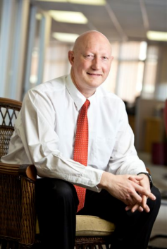 A person in a white shirt and red tie AI-generated content may be incorrect.
