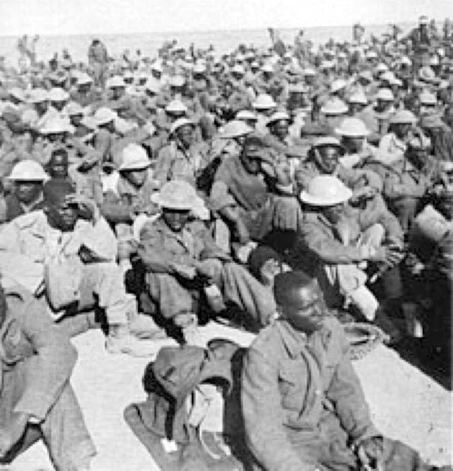 A large group of soldiers sitting on the ground AI-generated content may be incorrect.
