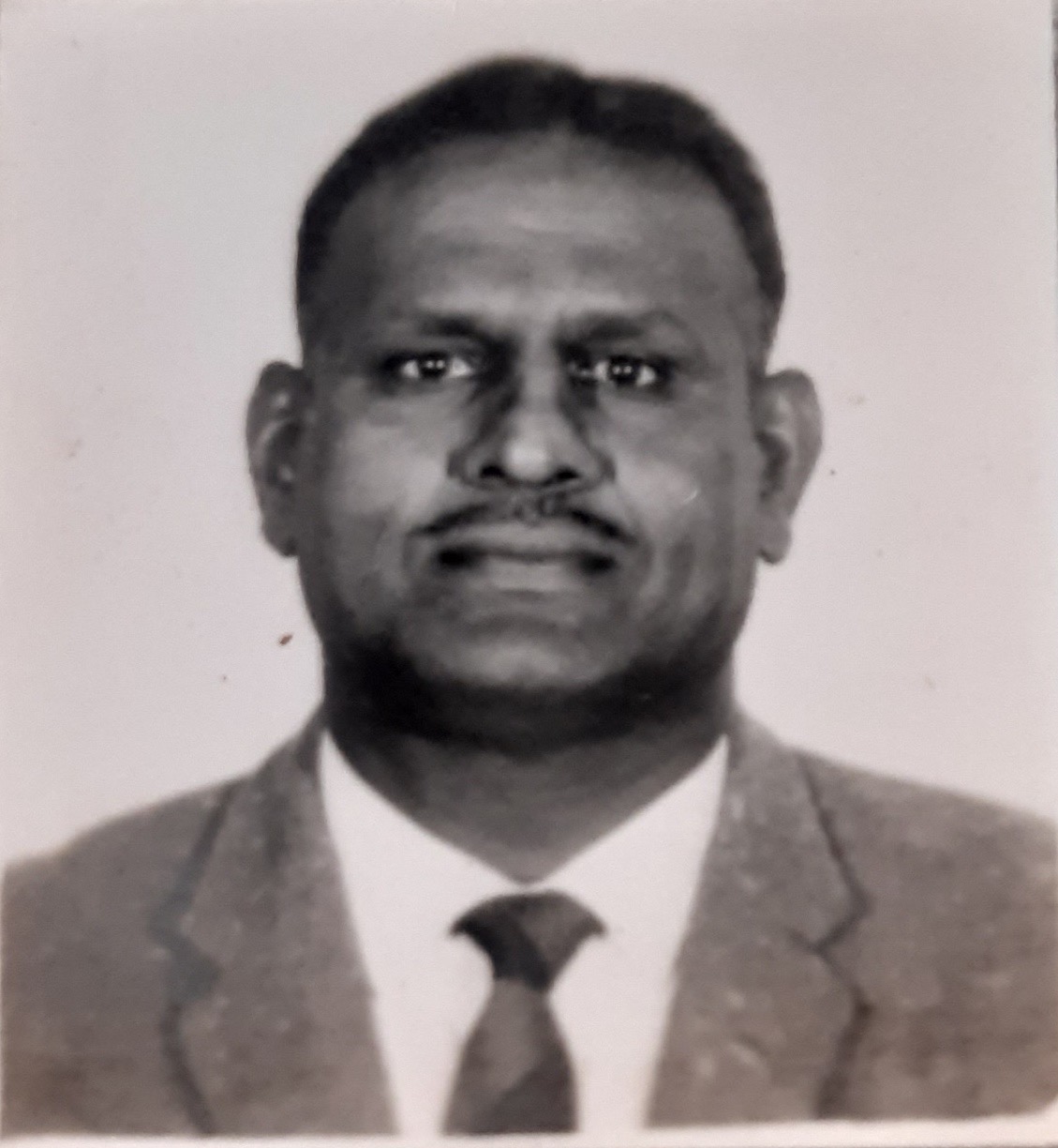 A person in a suit and tie AI-generated content may be incorrect.