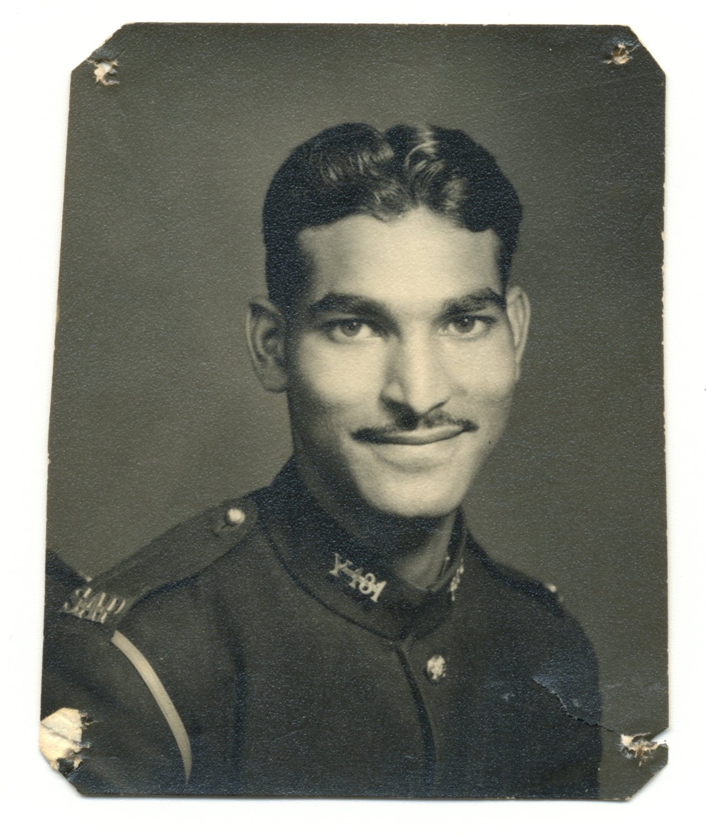 A person in uniform smiling AI-generated content may be incorrect.