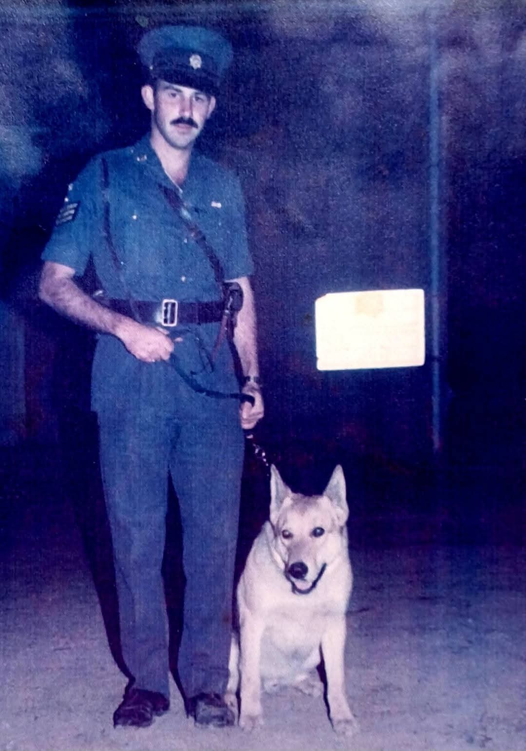 A person in uniform with a dog

AI-generated content may be incorrect.