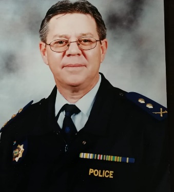 A portrait of a person in a police uniform

AI-generated content may be incorrect.