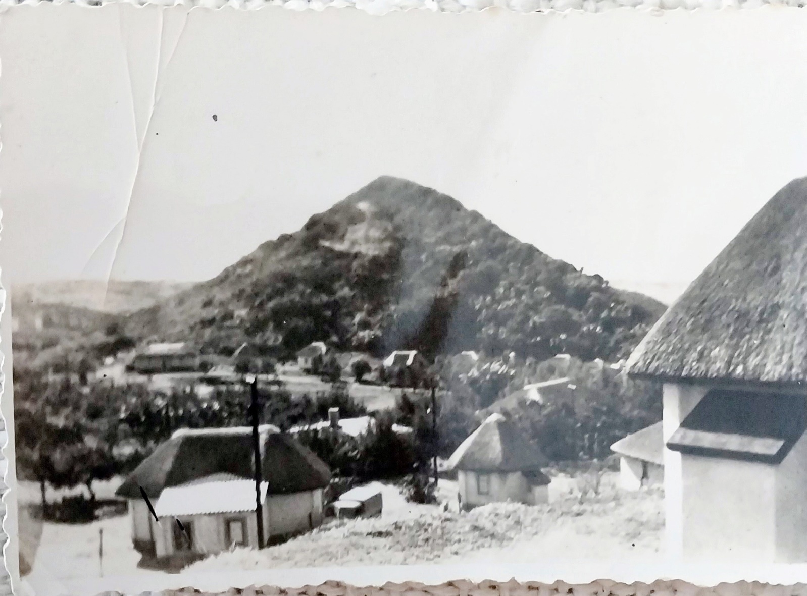 A black and white photo of a village

AI-generated content may be incorrect.