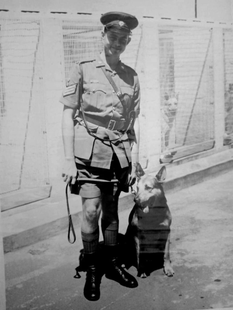 A person in uniform with a dog

AI-generated content may be incorrect.
