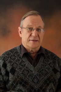 A person wearing a sweater and glasses

AI-generated content may be incorrect.