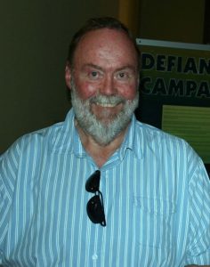 A person with a beard and mustache smiling AI-generated content may be incorrect.