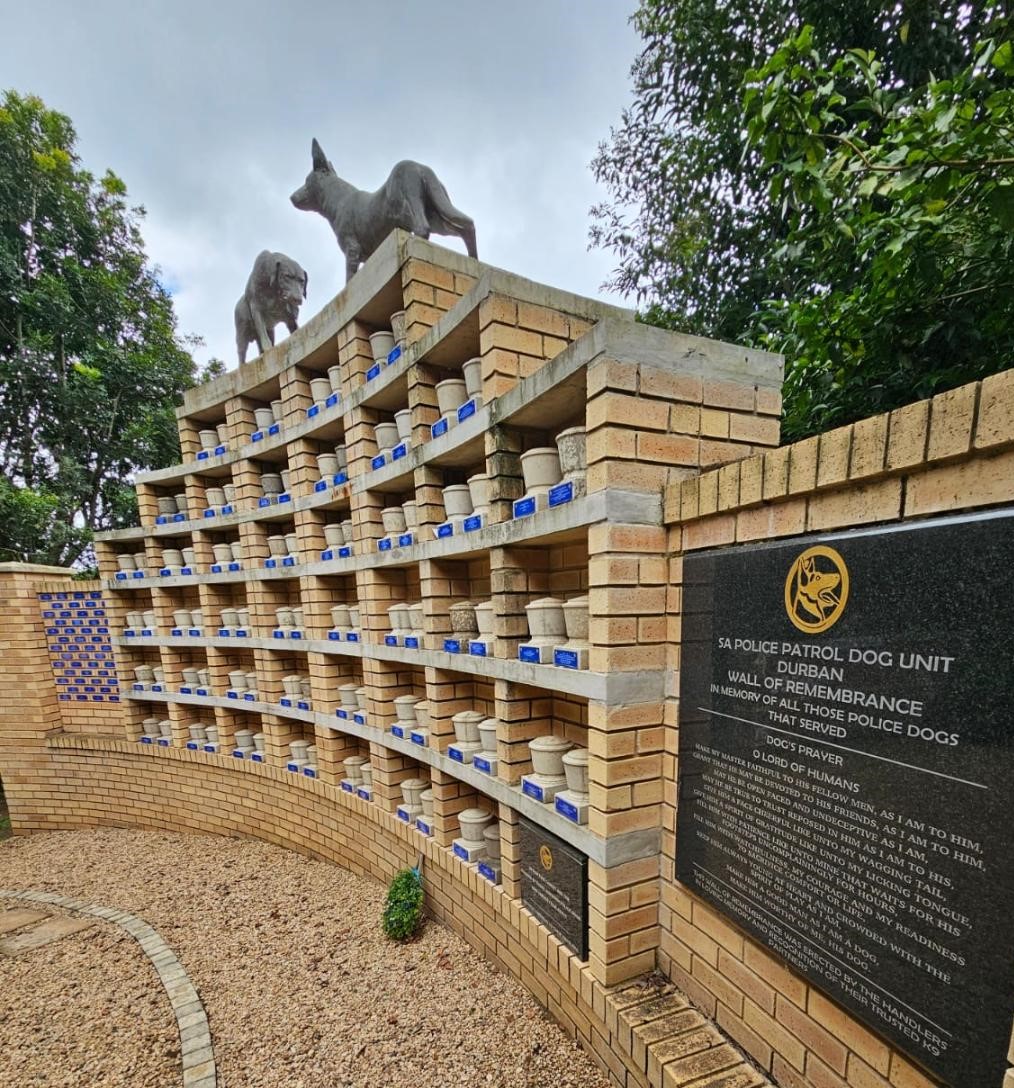 A stone dog memorial with a sign

AI-generated content may be incorrect.