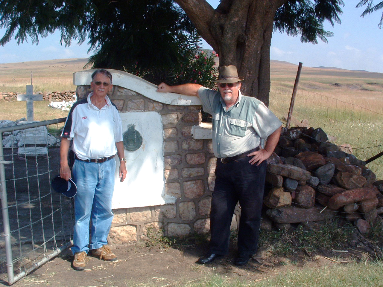Men standing next to a stone wall

AI-generated content may be incorrect.