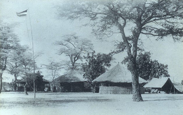 A group of huts in a field

AI-generated content may be incorrect.