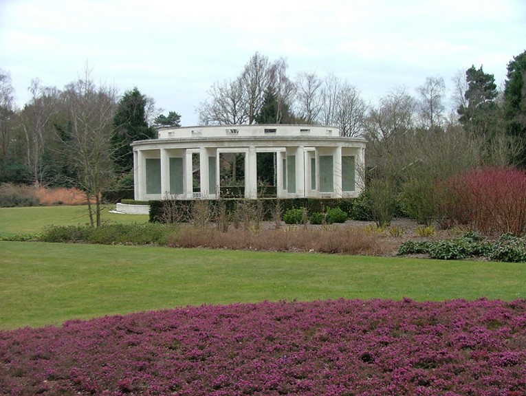 A white building with columns in front of a lawn

AI-generated content may be incorrect.