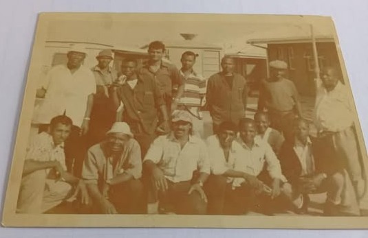 A group of people posing for a photo AI-generated content may be incorrect.