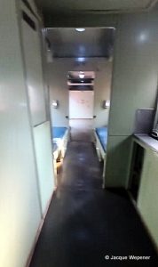 A hallway with a bed and a door
AI-generated content may be incorrect.