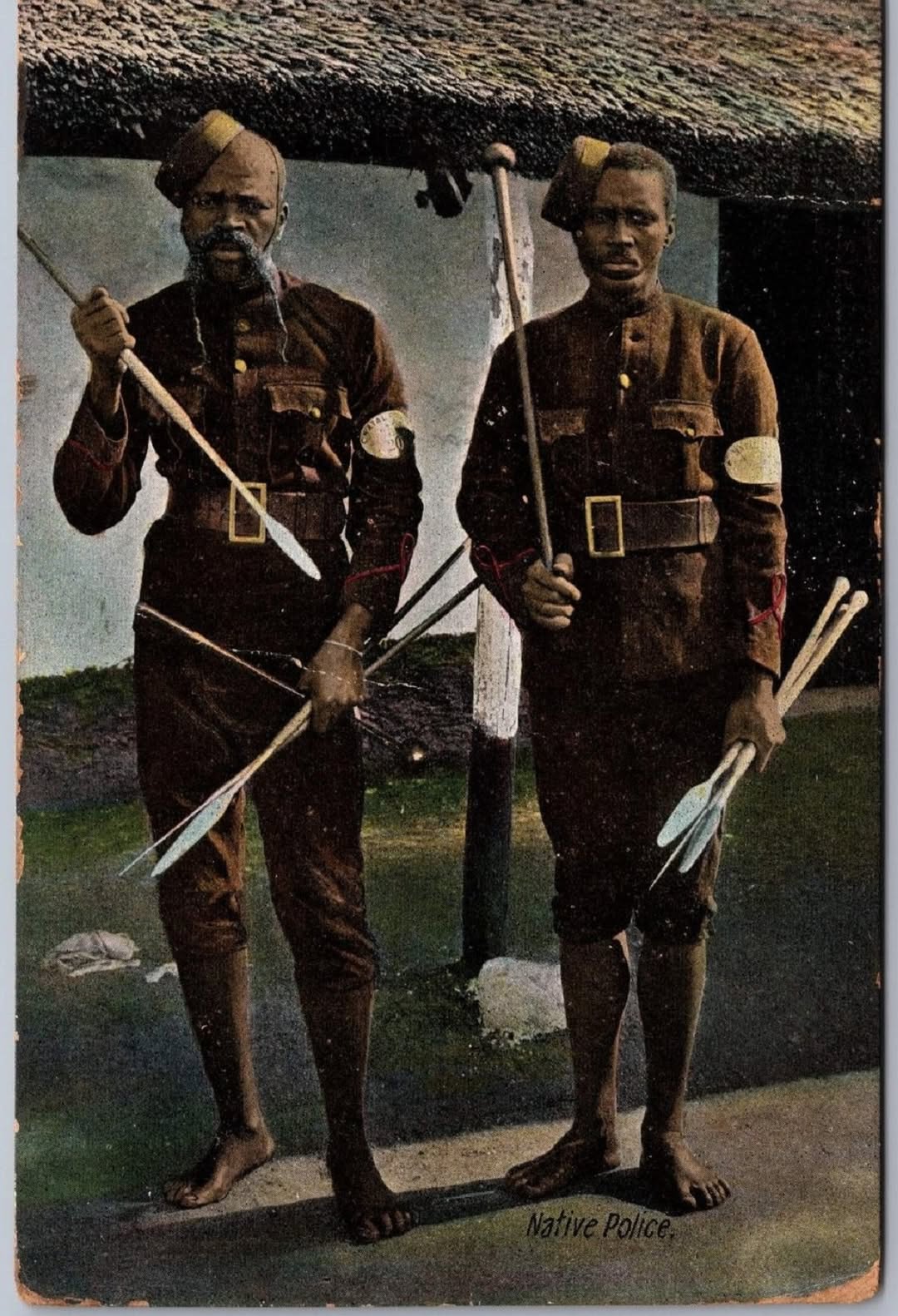 A couple of men in uniforms holding arrows AI-generated content may be incorrect.