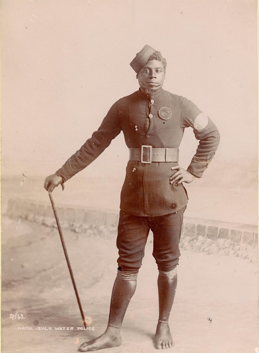 A person in uniform holding a cane AI-generated content may be incorrect.