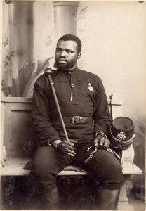 A person sitting on a bench holding a cane AI-generated content may be incorrect.