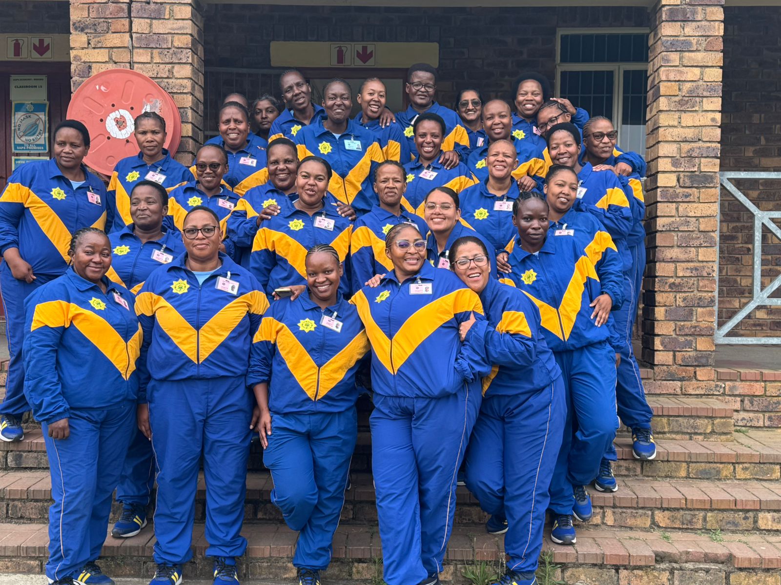 A group of people posing for a photo AI-generated content may be incorrect.