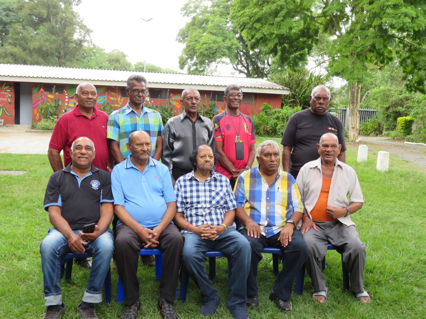 A group of men sitting on chairs AI-generated content may be incorrect.