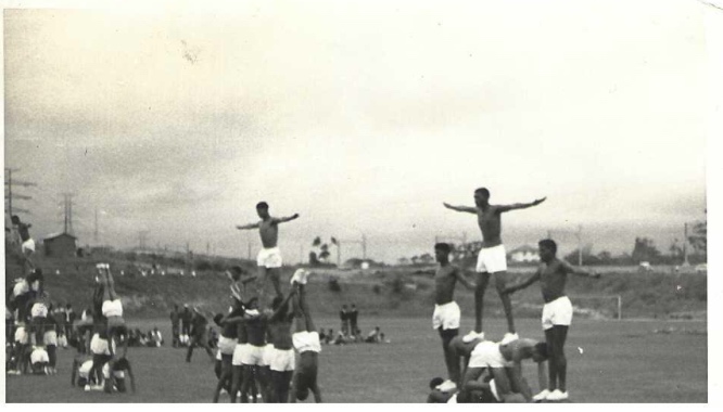 A group of men standing on each other AI-generated content may be incorrect.