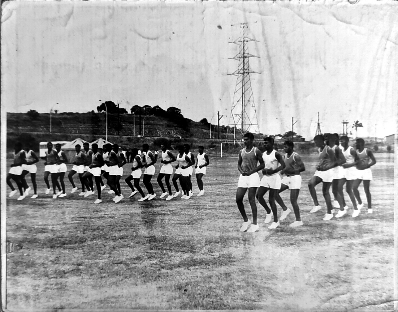 A group of people running on a field AI-generated content may be incorrect.