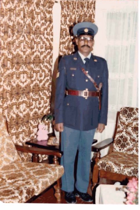 A person in a uniform standing in front of a chair
AI-generated content may be incorrect.