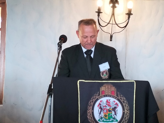 'n Foto wat klere, mikrofoon, pak, persoon bevat AI-gegenereerde inhoud kan dalk verkeerd wees.