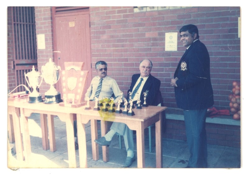 A group of men sitting at a table with chess pieces
AI-generated content may be incorrect.