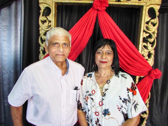 A person and person standing in front of a gold frame
AI-generated content may be incorrect.