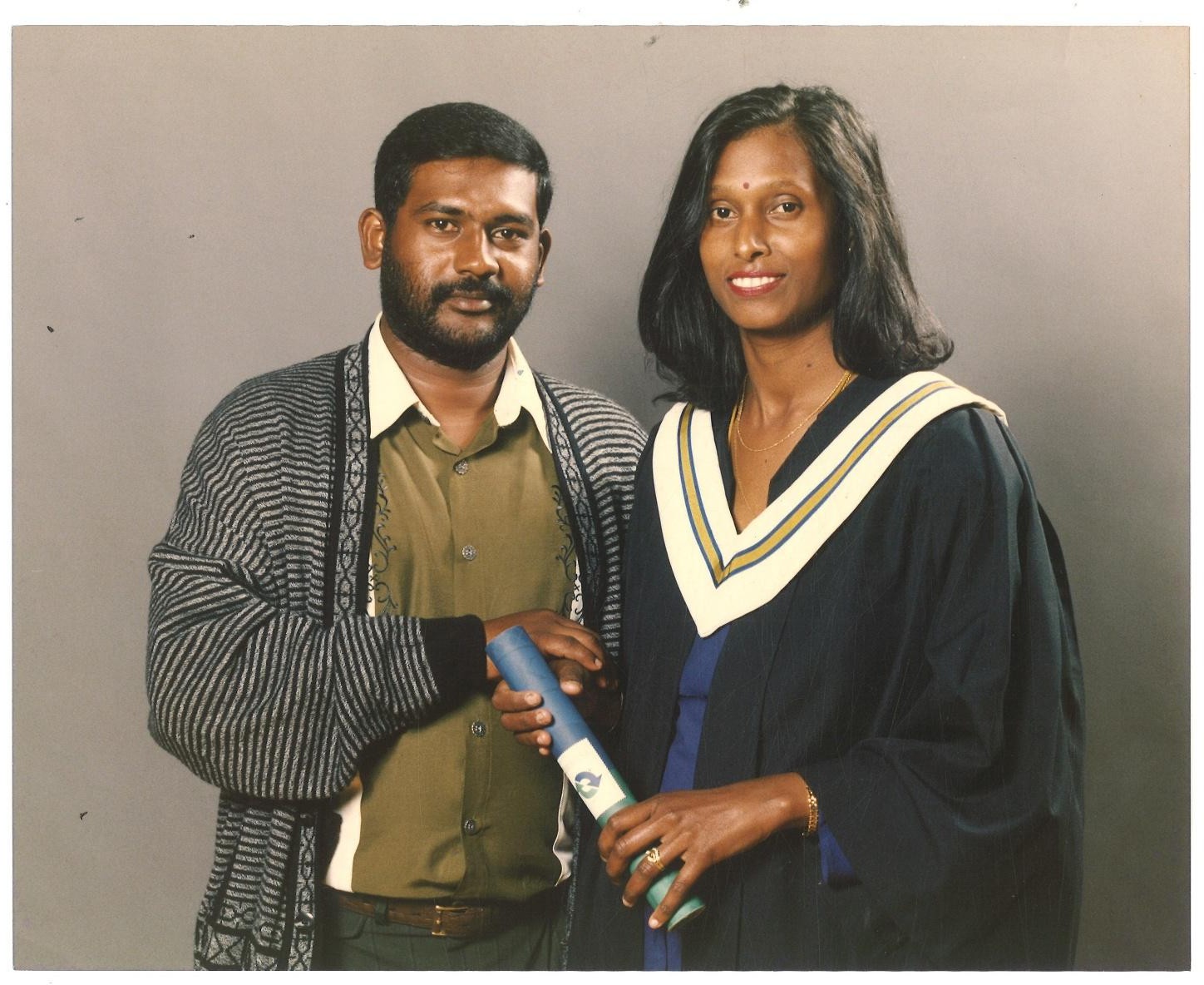 A person and person in graduation gowns AI-generated content may be incorrect.