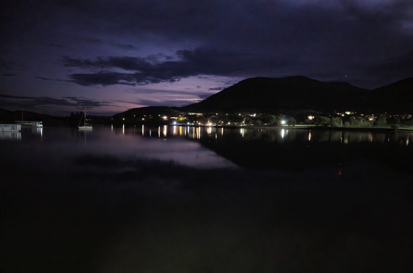 A body of water with a mountain in the background AI-generated content may be incorrect.