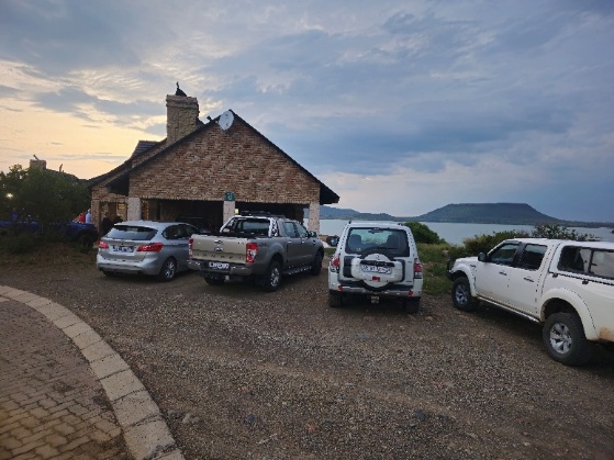 A group of cars parked in front of a house AI-generated content may be incorrect.
