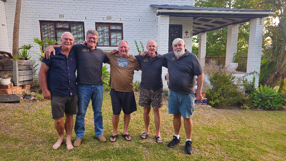 A group of men standing in a yard AI-generated content may be incorrect.