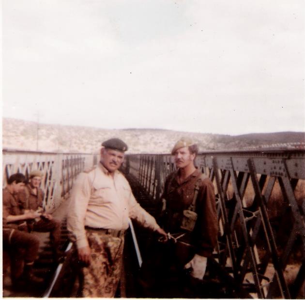 A group of men standing on a bridge AI-generated content may be incorrect.
