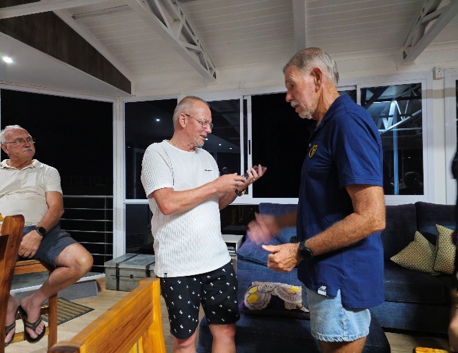 A group of men talking in a room AI-generated content may be incorrect.