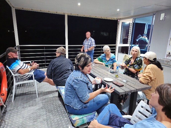 A group of people sitting around a table AI-generated content may be incorrect.
