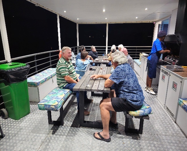 A group of people sitting at a table AI-generated content may be incorrect.
