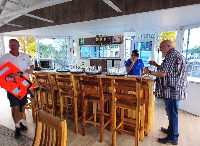 A group of people standing around a bar AI-generated content may be incorrect.