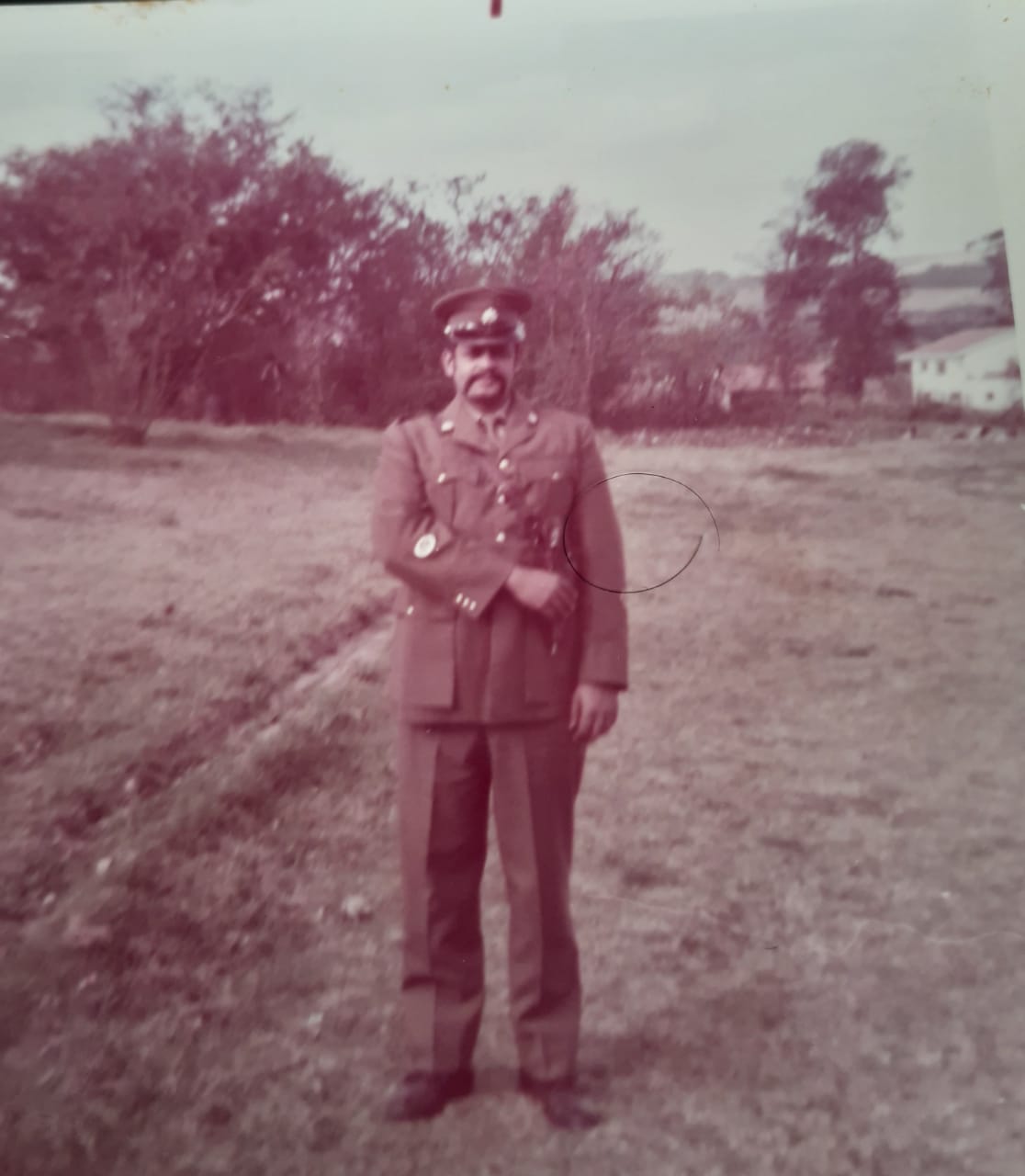 A person in a uniform standing on a path AI-generated content may be incorrect.