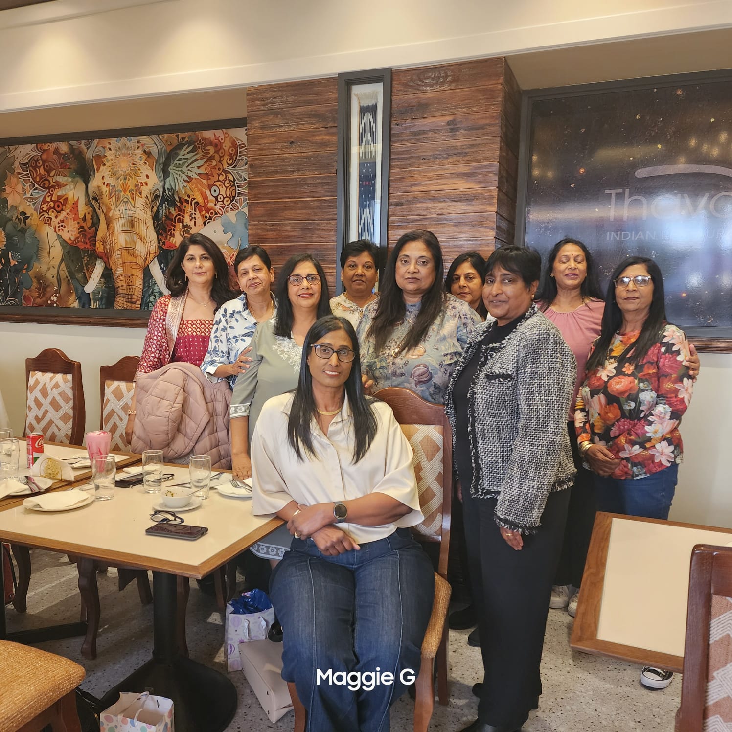 A group of women posing for a photo AI-generated content may be incorrect.