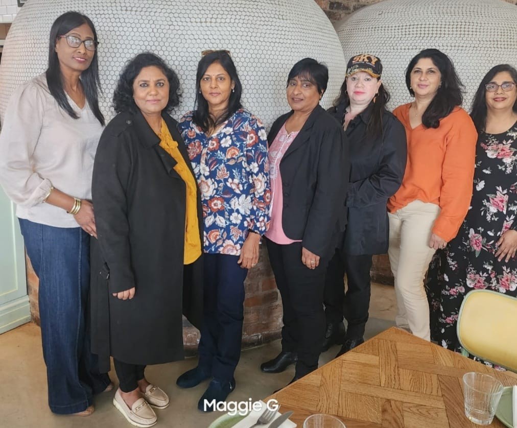 A group of women standing together AI-generated content may be incorrect.