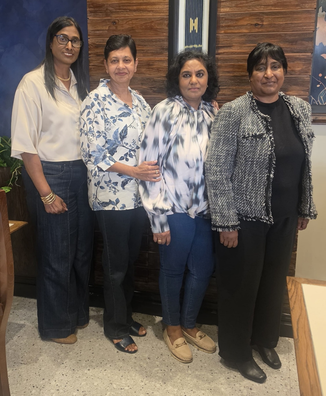 A group of women standing together AI-generated content may be incorrect.