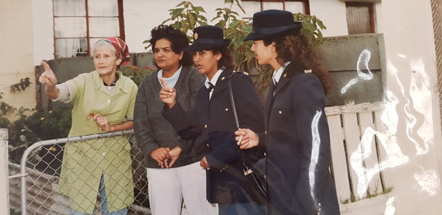 A group of women in uniform AI-generated content may be incorrect.
