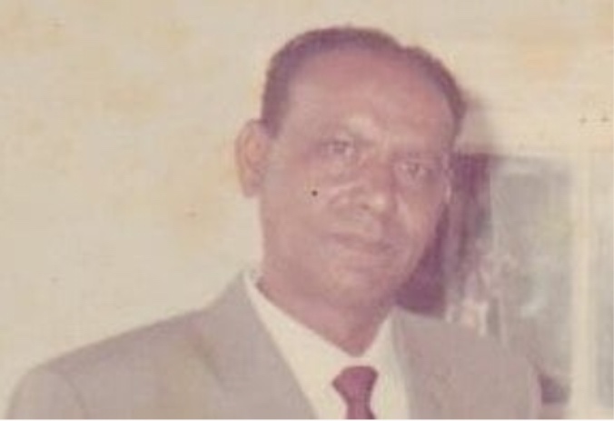 A person in a suit and tie AI-generated content may be incorrect.