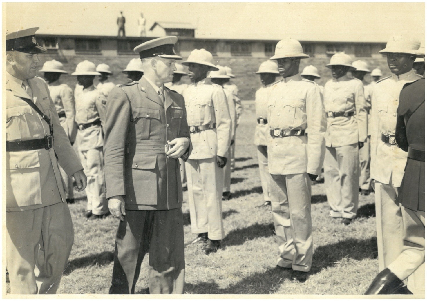 A person in military uniform standing in a line AI-generated content may be incorrect.